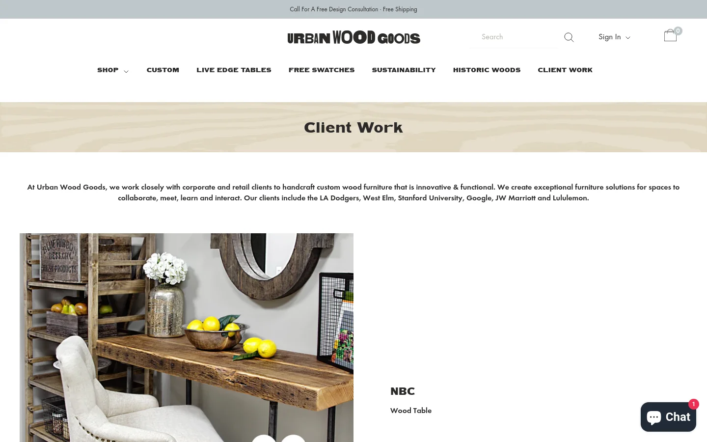 The Client Work page features a clean white layout with a light wood grain banner at the top containing the title. Below the header, a text introduction is followed by a large featured project image showing a rustic wood table with lemons and a white chair, alongside the NBC logo. The desktop navigation includes links for Shop, Custom, Live Edge Tables, and more.