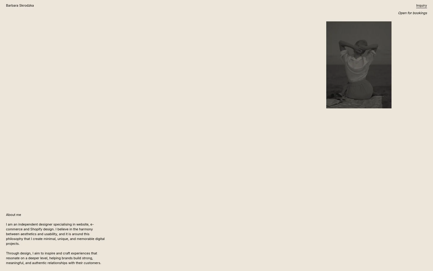 The desktop About Me page features a minimalist design with a light beige background and black serif typography. The layout consists of a header with the name 'Barbara Skrodzka' and an 'Inquiry' link, a large black and white portrait of a woman on the right, and biographical text on the left. A primary call to action, 'Open for bookings,' sits below the inquiry link.