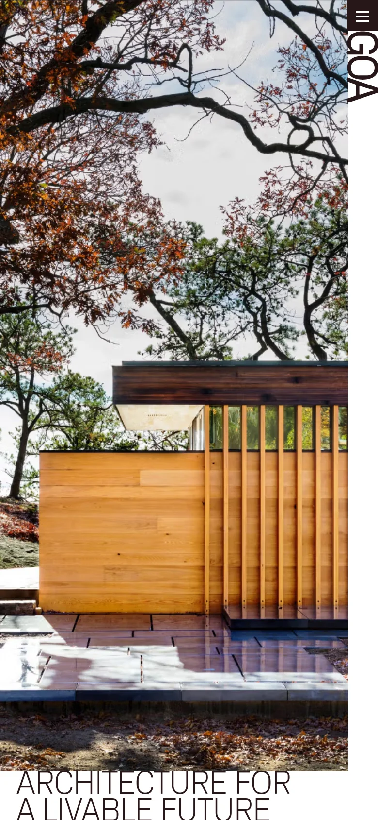 The mobile version maintains the minimalist aesthetic, showing a vertically oriented hero image of a light wood structure framed by tree branches. The headline 'ARCHITECTURE FOR A LIVABLE FUTURE' is positioned at the bottom, and the 'GOA' logo and menu icon are stacked at the top right.