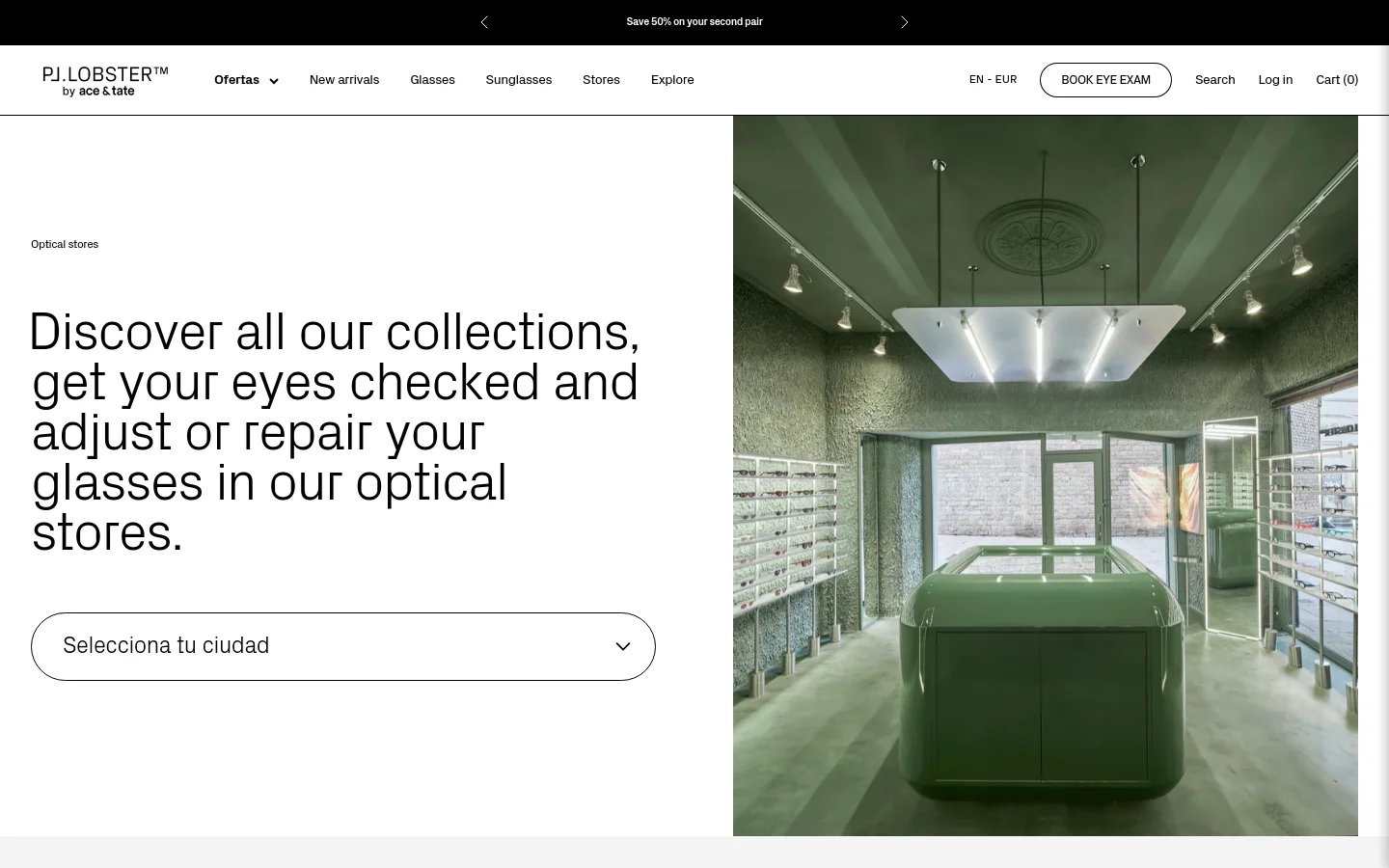 The desktop page features a minimalist layout with a large heading on the left and a wide hero image of a modern, green-toned optical store on the right. A city selection dropdown menu sits below the text, and a navigation bar at the top includes links for New arrivals, Glasses, Sunglasses, Stores, and Explore.