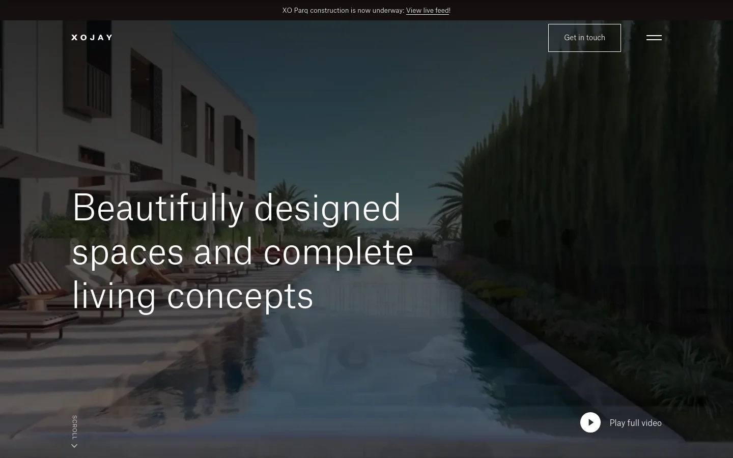 The desktop homepage features a full-screen cinematic video background of a luxury swimming pool and modern architecture under a clear sky. Centered white text reads 'Beautifully designed spaces and complete living concepts,' with a 'Get in touch' button in the top right and a 'Play full video' button at the bottom right. A thin black announcement bar at the very top contains a link to a live construction feed.