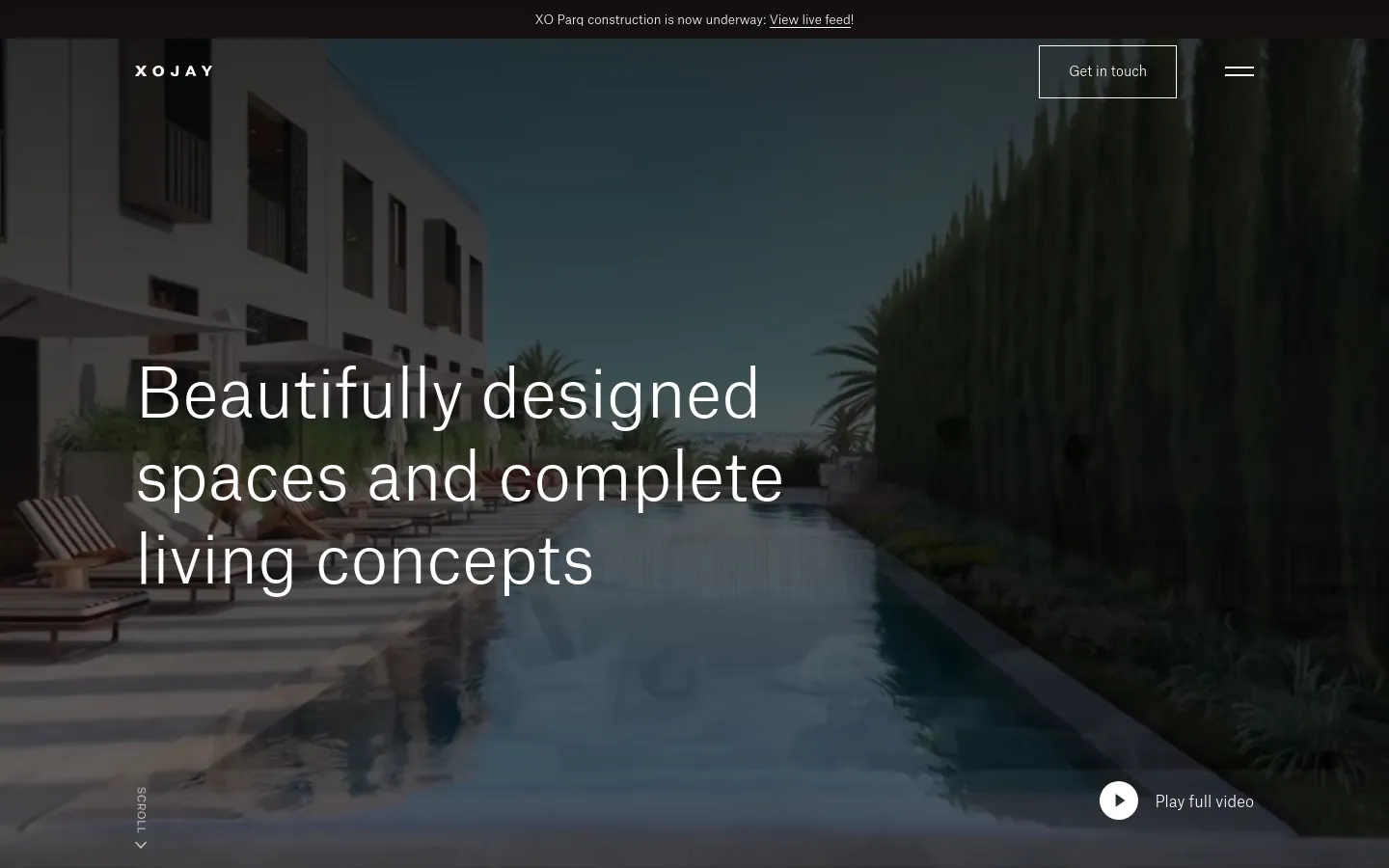 The desktop homepage features a full-screen cinematic video background of a luxury swimming pool and modern architecture under a clear sky. Centered white text reads 'Beautifully designed spaces and complete living concepts,' with a 'Get in touch' button in the top right and a 'Play full video' button at the bottom right. A thin black announcement bar at the very top contains a link to a live construction feed.