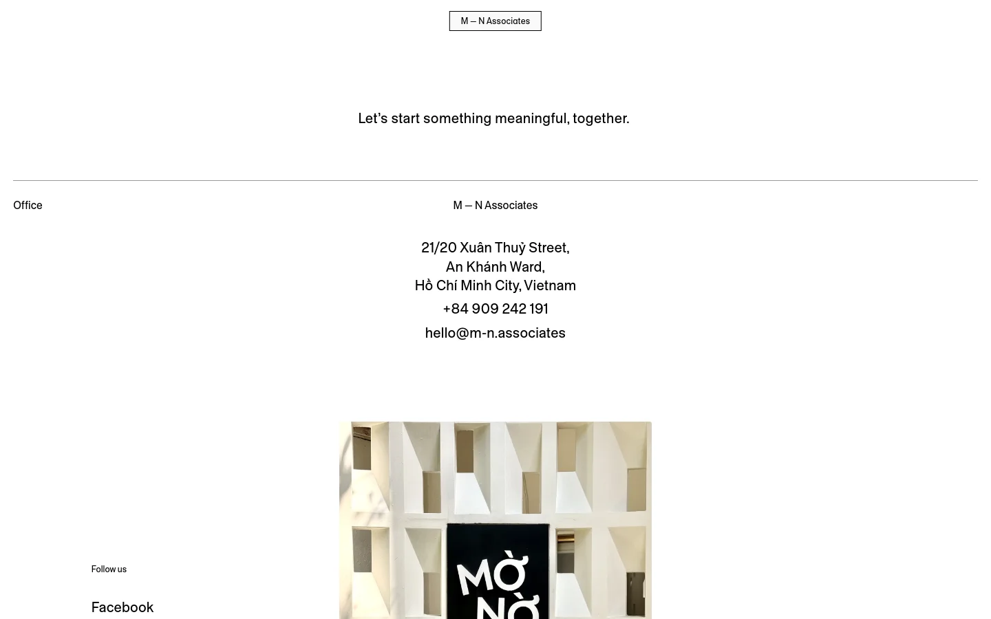 The desktop contact page features a minimalist white background with centered black text. A large headline reads 'Let's start something meaningful, together,' followed by a horizontal divider and contact details including the office address, phone number, and email. A large architectural photograph of a geometric white facade with a black sign is positioned at the bottom.