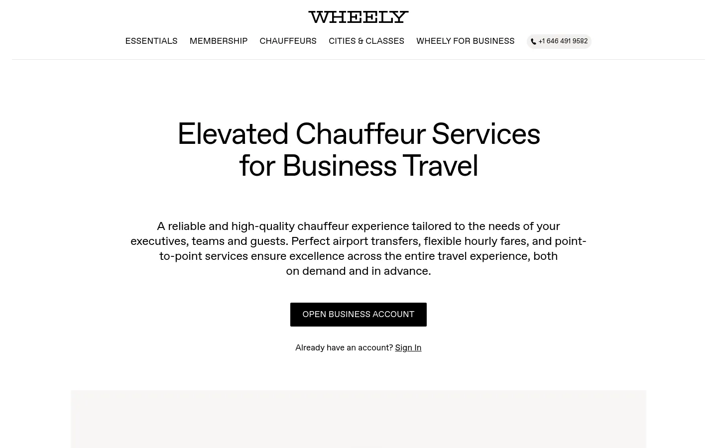 The desktop page features a clean, minimalist white background with the Wheely logo at the top center and a navigation menu below it. The hero section displays a large headline, 'Elevated Chauffeur Services for Business Travel,' followed by a descriptive paragraph and a prominent black 'OPEN BUSINESS ACCOUNT' button. A phone number contact button is located in the top right corner.