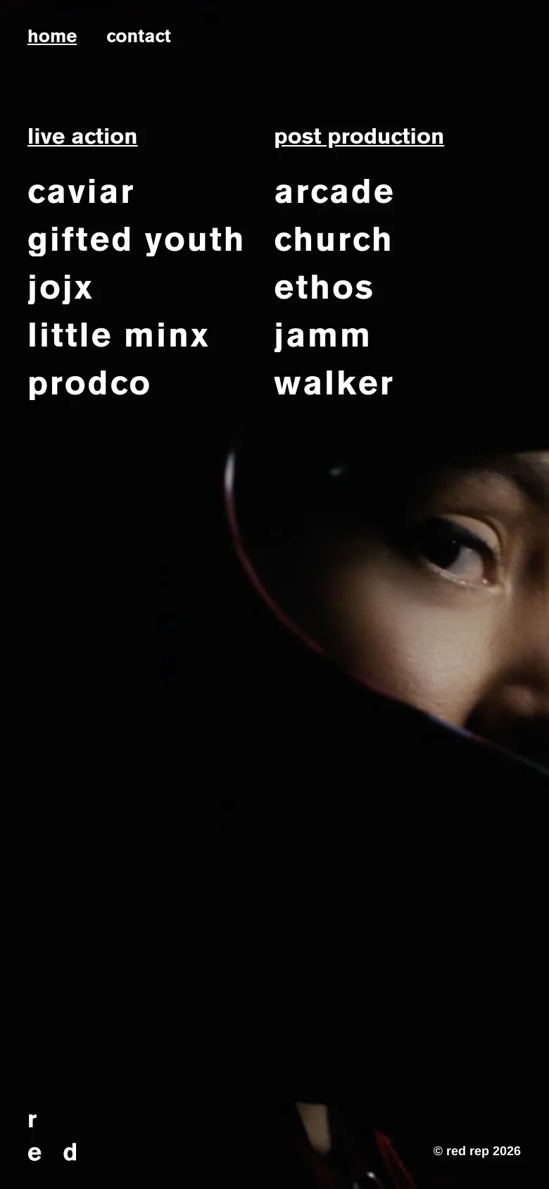 The mobile version maintains the dark aesthetic with a close-up portrait background, but the layout shifts to a vertical stack. The client lists are positioned above the main image, and the navigation links 'home' and 'contact' are moved to the top left of the screen.