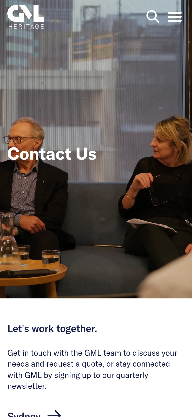 The mobile version displays a vertically stacked layout starting with a full-width hero image of people in a meeting and the 'Contact Us' title. A hamburger menu and search icon are visible in the header, followed by the 'Let's work together' heading and introductory text on a white background.