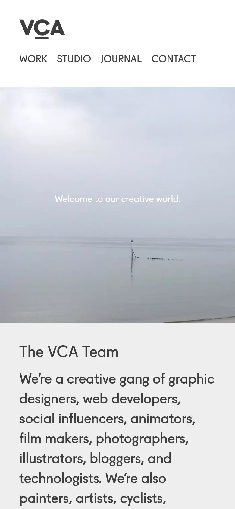 The mobile version displays a centered VCA logo above a stacked navigation menu including Work, Studio, Journal, and Contact. The hero image of a misty seascape remains prominent below the header, with text centered over the water.