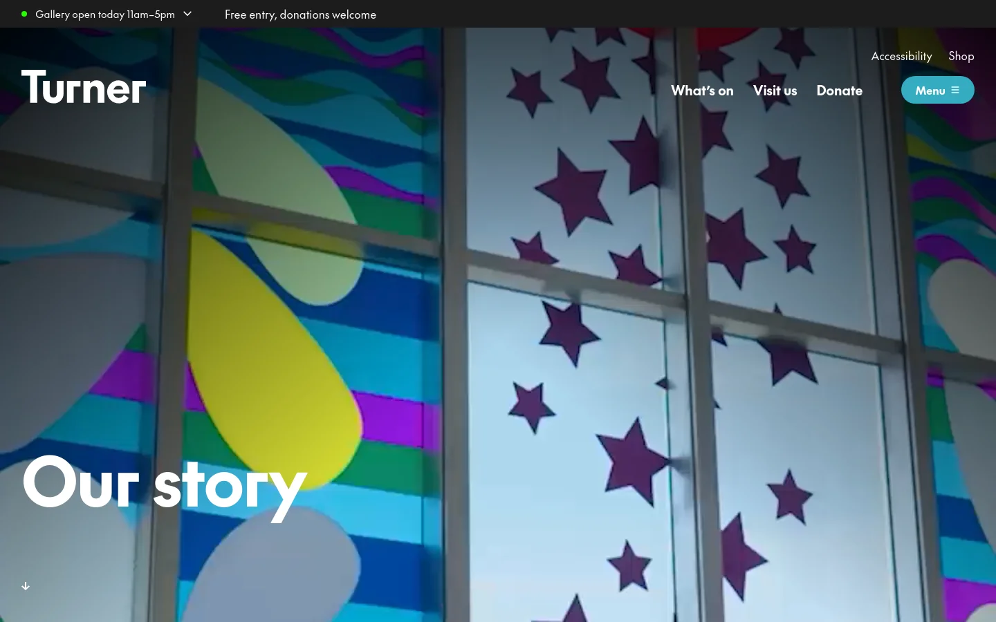 The desktop page features a large hero image of a colorful, star-patterned window installation with the headline 'Our story' in bold white text. A top navigation bar includes the Turner logo, links for 'What's on', 'Visit us', and 'Donate', and a 'Menu' button. The layout is clean with a dark top bar indicating gallery hours and a minimalist aesthetic.