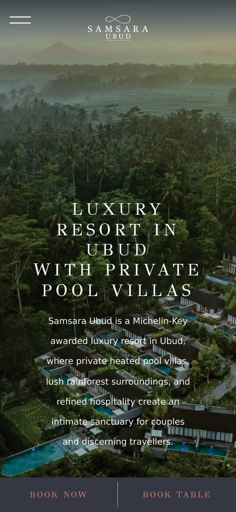 The mobile version uses the same misty rainforest hero image but scales the large, centered white serif headline to fit the vertical screen. The top navigation is simplified with a hamburger menu and logo, while two prominent call-to-action buttons, 'BOOK NOW' and 'BOOK TABLE', are fixed to the bottom of the screen.