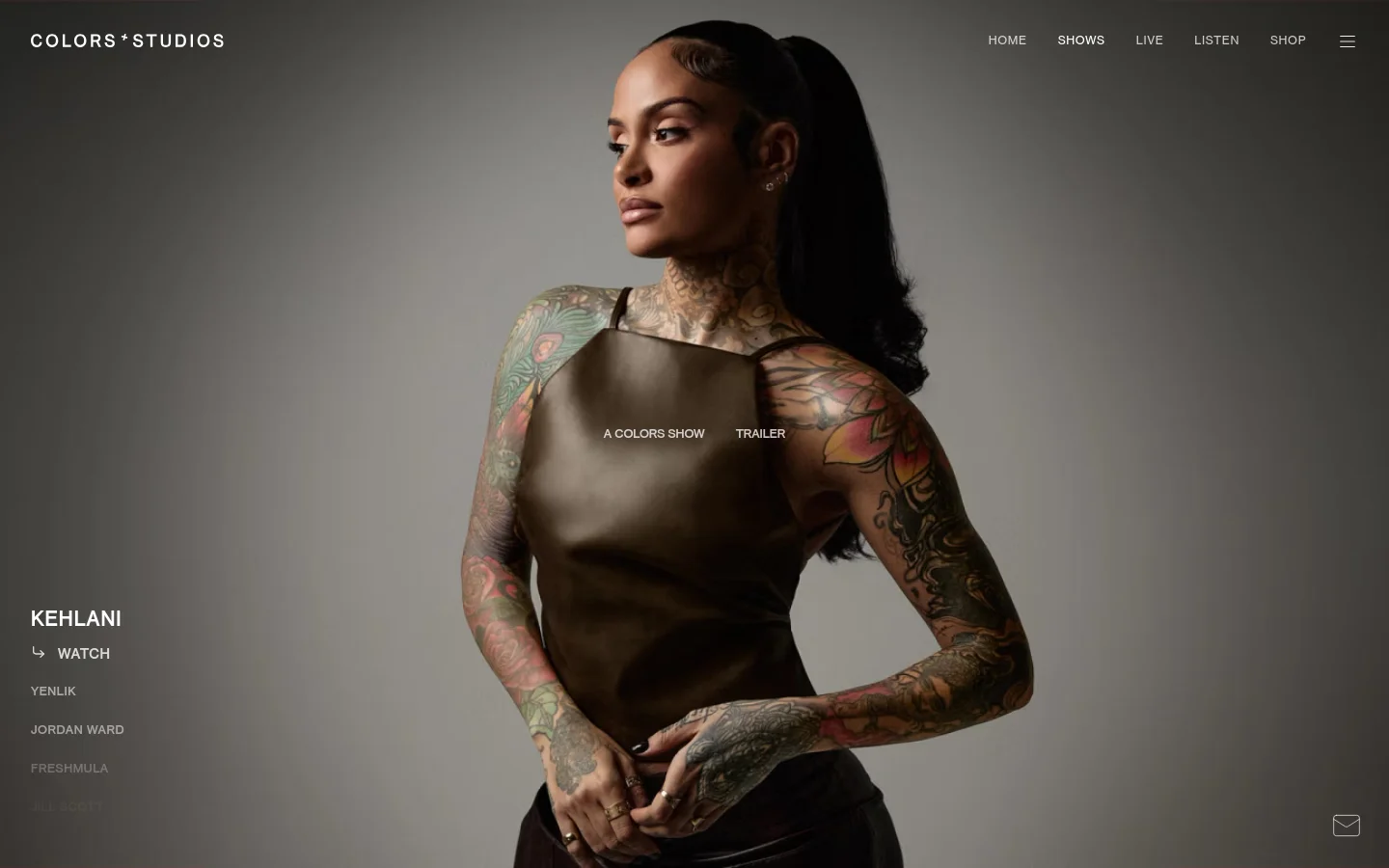 The desktop page features a large hero image of artist Kehlani against a neutral gray background, with a navigation menu at the top right. A vertical list of artist names is on the left, and primary calls to action for 'A COLORS SHOW' and 'TRAILER' are overlaid on the center of the image.