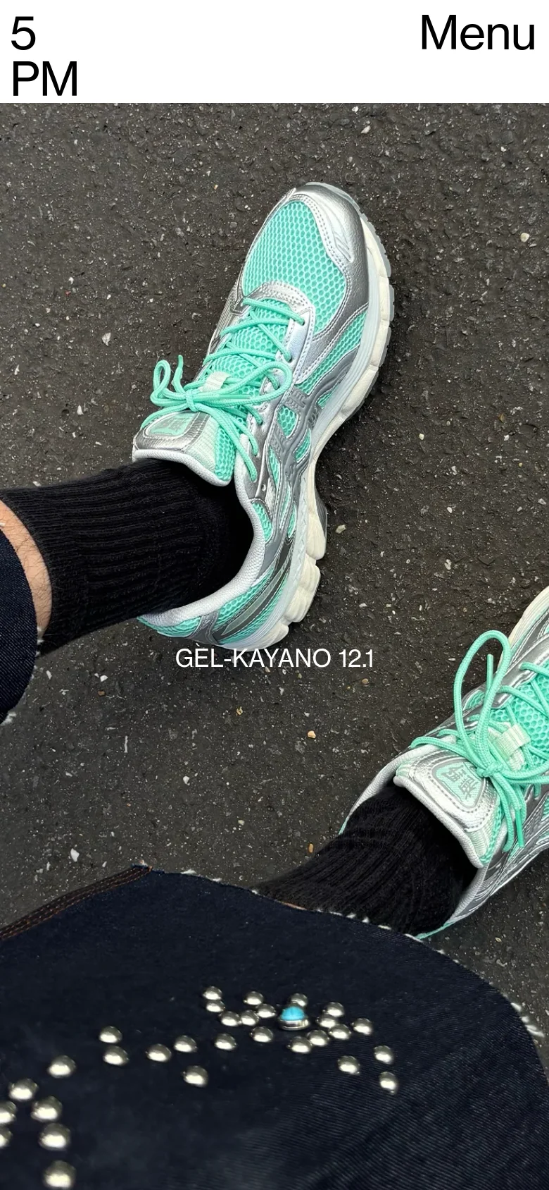 The mobile version presents a vertically stacked layout centered on the close-up imagery of the teal sneakers and black socks. The large black graphic element is more prominent, and the navigation is simplified into a 'Menu' button at the top right, while the '5 PM' brand name remains at the top left.