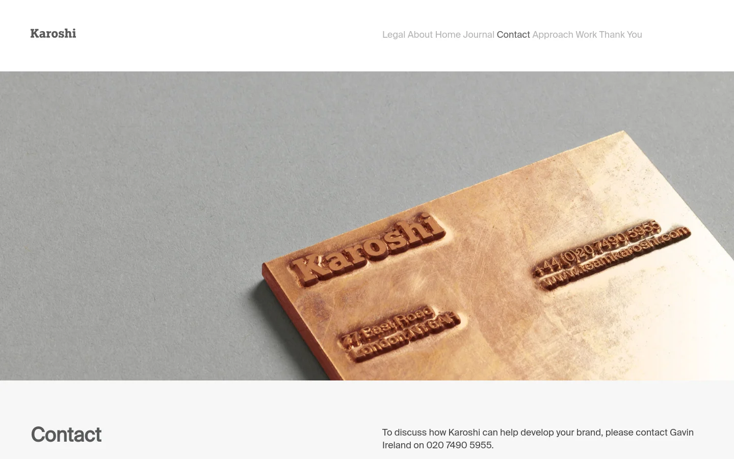 The desktop contact page features a minimalist design with a large hero image of a copper-colored embossed block against a grey background. A navigation menu is at the top right, and the main content area below the image contains a large 'Contact' headline followed by text providing contact instructions and a phone number.
