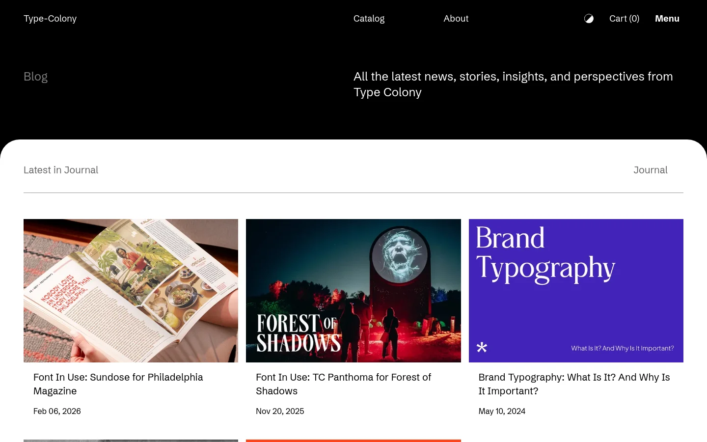The Journal blog page features a minimalist black hero section with white text reading 'Blog' and a description of the site's purpose. Below, a white content area displays a grid of blog posts, each consisting of a large rectangular featured image, a bold headline, and a publication date. The layout is clean with ample white space and a navigation bar at the top containing links for Catalog, About, and a shopping cart.