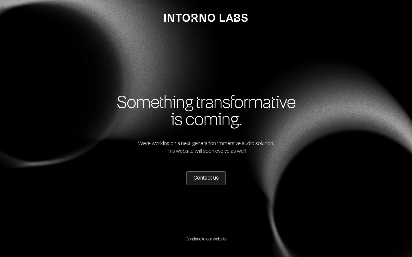 A dark, minimalist landing page for Intorno Labs featuring abstract, glowing white light shapes against a black background. The center displays the headline 'Something transformative is coming.' followed by text about a next-generation immersive audio solution and a 'Contact us' button.