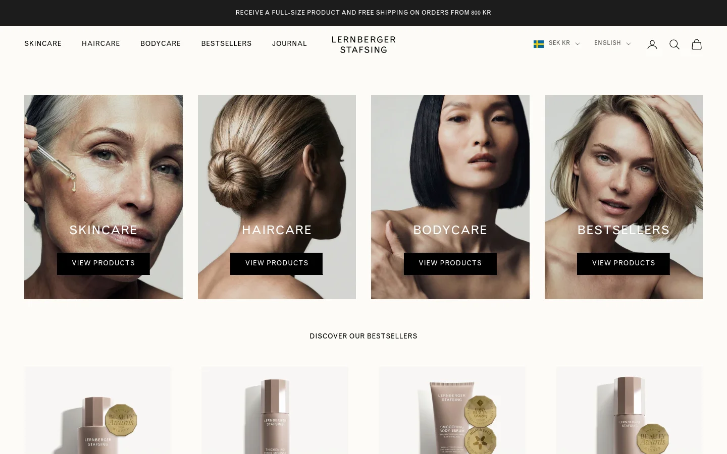 The desktop homepage features a clean, minimalist design with a white background and a top navigation bar for Skincare, Haircare, Bodycare, Bestsellers, and Journal. Below the header, four large, side-by-side rectangular images showcase close-up portraits of models representing Skincare, Haircare, Bodycare, and Bestsellers, each with a 'View Products' call-to-action button. A section titled 'Discover our Bestsellers' follows, displaying product images against a light background.