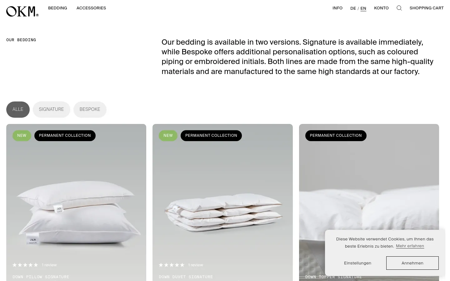 The desktop page features a clean, minimalist layout with a white background and black text. A large headline introduces the bedding collections, followed by three pill-shaped filter buttons: 'ALLE', 'SIGNATURE', and 'BESPOKE'. Below, a grid of product cards displays high-quality images of white pillows and duvets, each with labels like 'NEW' or 'PERMANENT COLLECTION' and pricing information.