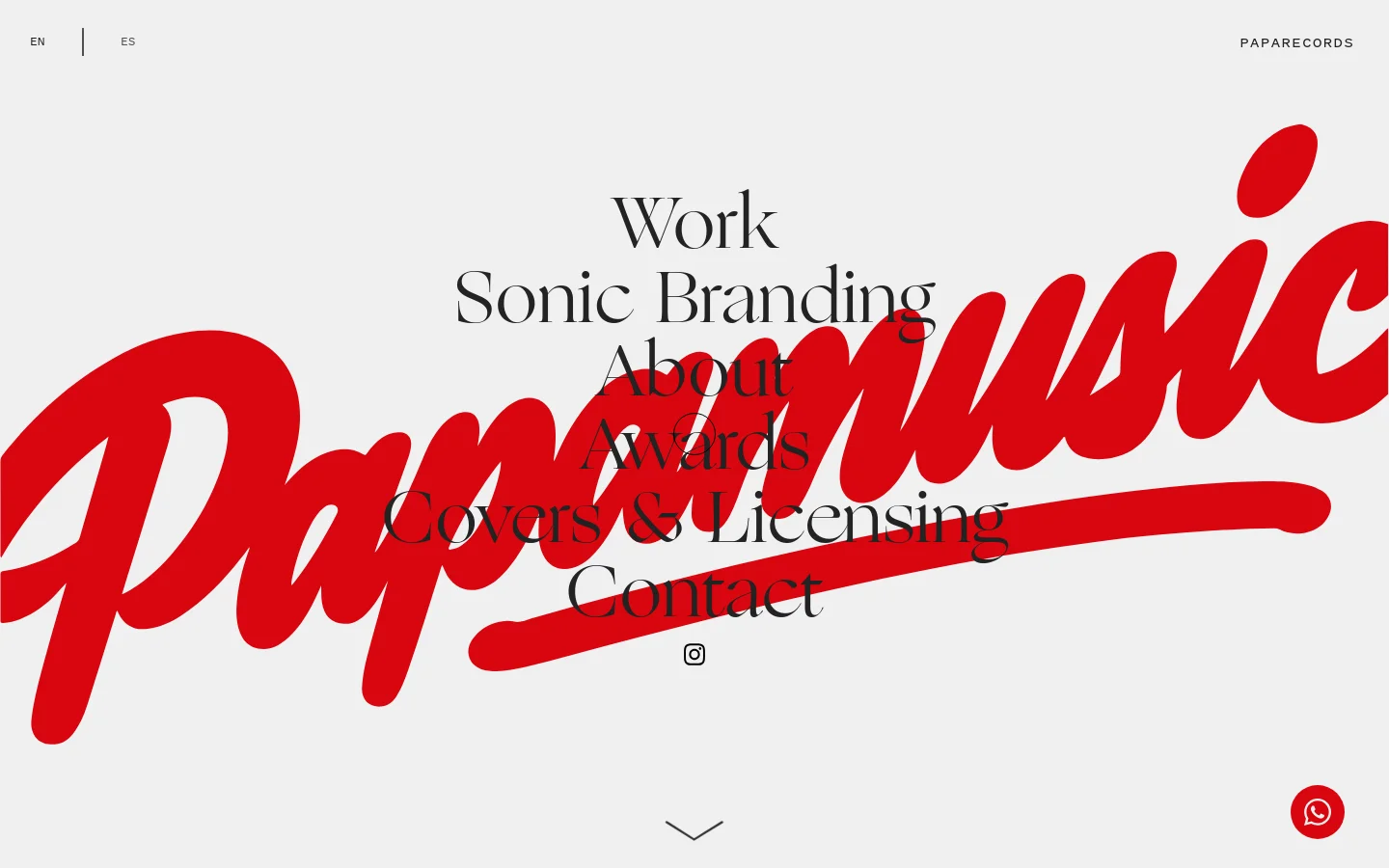 The homepage features a minimalist light gray background with a large, red, stylized script logo reading 'Papamusic' layered behind a centered navigation menu. The menu includes text links for Work, Sonic Branding, About, Awards, Covers & Licensing, and Contact, with language toggles (EN/ES) at the top left and 'PAPARECORDS' at the top right. A small Instagram icon and a downward arrow are positioned at the bottom center.