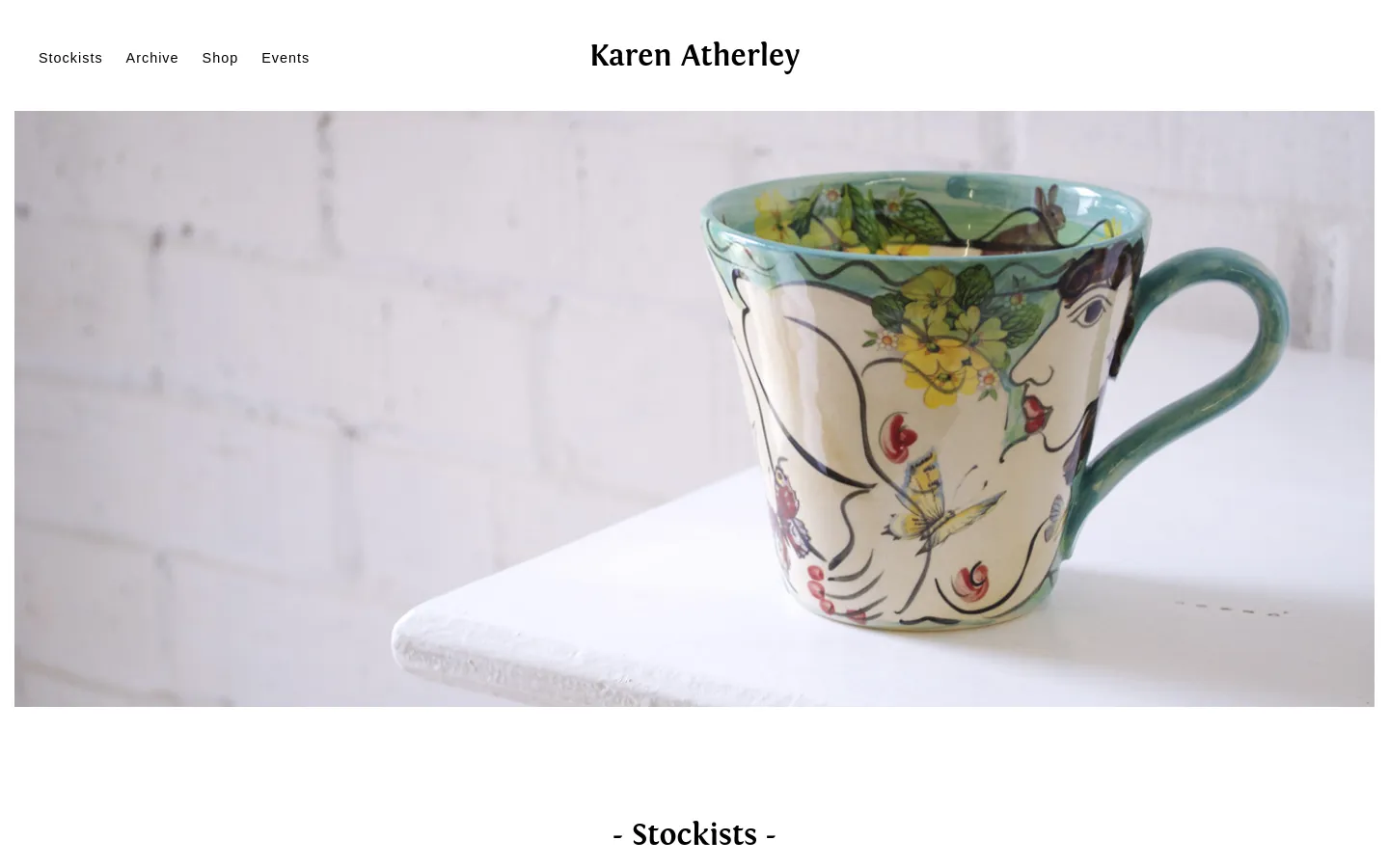 The desktop version features a clean white header with the brand name 'Karen Atherley' centered and navigation links on the left. Below the header is a large hero image of a decorated ceramic mug against a white brick background, followed by a centered '- Stockists -' heading and a vertical list of retail locations with addresses and phone numbers.