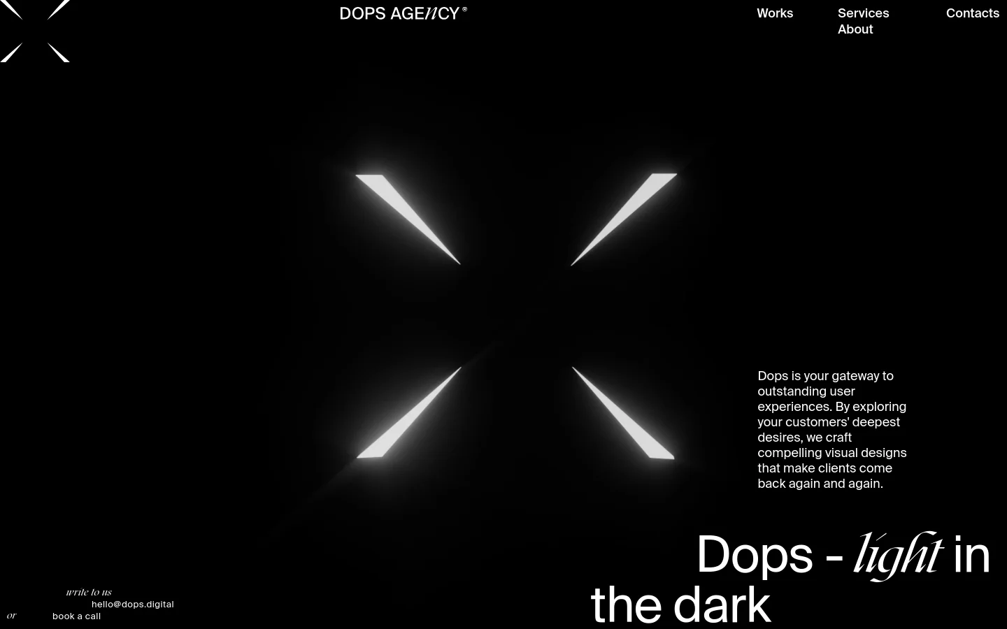 The desktop homepage features a minimalist dark theme with a large, glowing white X-shaped light effect in the center. The layout includes a top navigation menu with links for Works, Services, Contacts, and About, while the hero section displays the headline 'Dops - light in the dark' alongside contact information and a 'book a call' call to action.