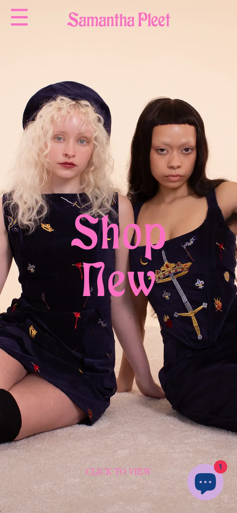 The mobile version presents a vertically oriented hero image of the same two models, with the pink 'Shop New' text scaled to fit the center of the screen. The top navigation is simplified to a hamburger menu icon on the left and the brand name in the center, with a floating chat icon in the bottom right corner.