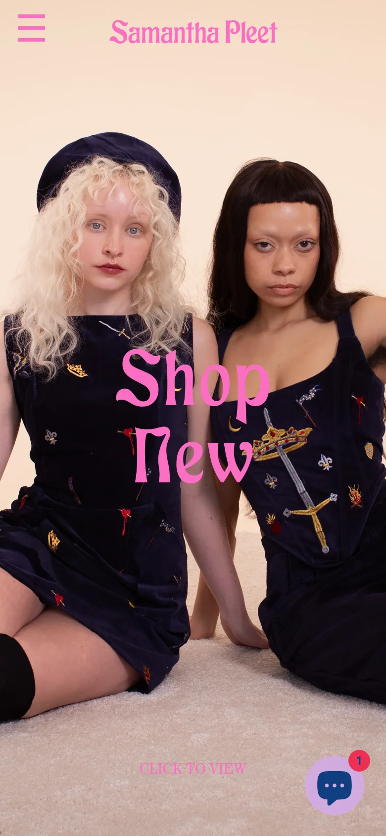 The mobile version presents a vertically oriented hero image of the same two models, with the pink 'Shop New' text scaled to fit the center of the screen. The top navigation is simplified to a hamburger menu icon on the left and the brand name in the center, with a floating chat icon in the bottom right corner.