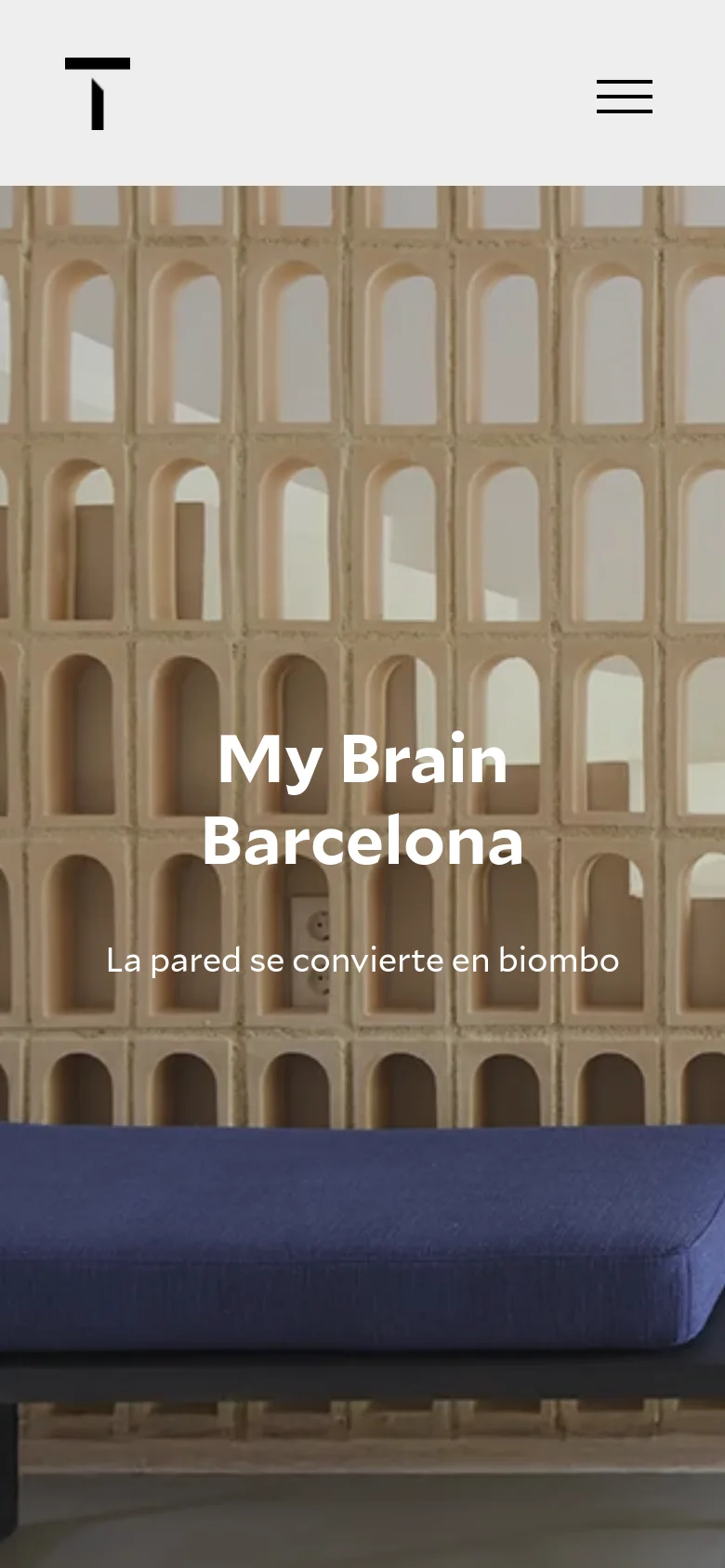 The mobile version simplifies the layout with a centered black logo and a hamburger menu icon on the right. The content shifts to a single-column vertical scroll, starting with a full-width hero image for 'My Brain Barcelona' featuring a patterned wall and blue seating, overlaid with large white text. The overall aesthetic remains clean and minimalist with a focus on large-scale imagery.