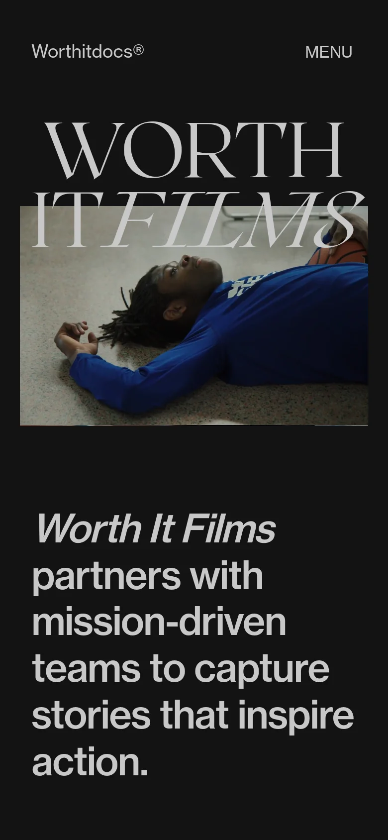The mobile version uses a stacked layout with the 'Worthitdocs®' logo and a 'MENU' button at the top. The large 'WORTH IT FILMS' headline remains central over a video background, followed by a large, bold text block stating the company's mission to capture stories that inspire action.