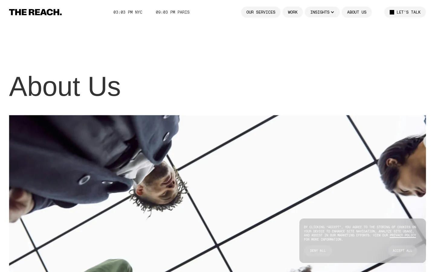 The desktop About Us page features a clean, minimalist layout with a large 'About Us' headline and a wide hero image showing people looking up through a glass ceiling. The navigation bar at the top includes the agency logo, time zones, and links for services, work, insights, about us, and a 'Let's Talk' button. A cookie consent banner is visible in the bottom right corner over the hero image.