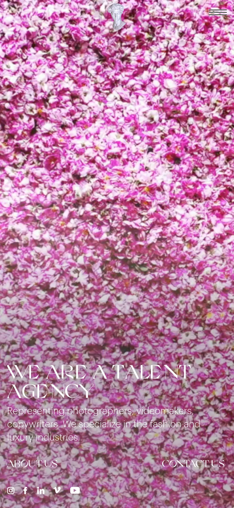 The mobile version maintains the pink floral hero image but shifts the layout to a vertical orientation. The headline 'WE ARE A TALENT AGENCY' and subtext are stacked centrally, while the navigation links and social icons are repositioned to fit the narrower screen width.
