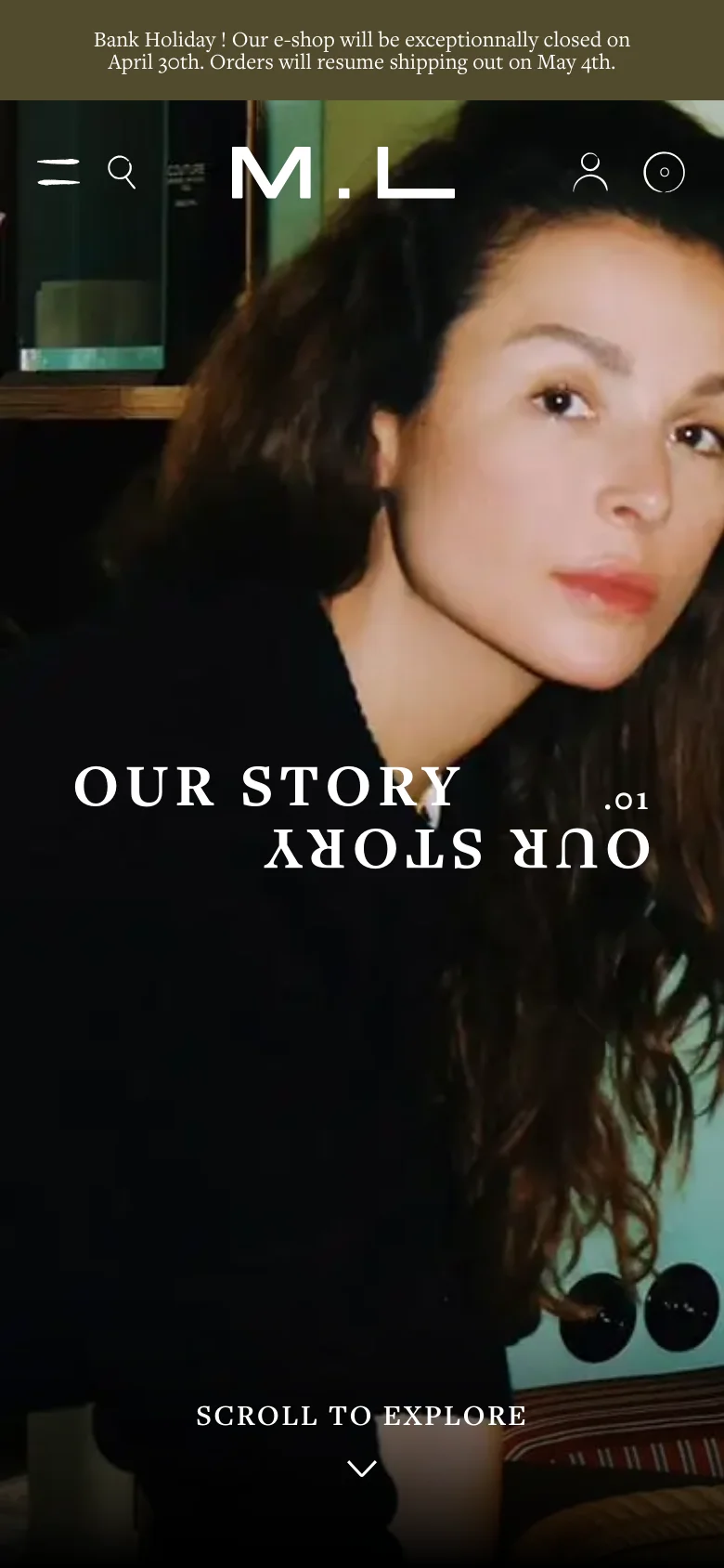 The mobile version presents a vertically oriented, zoomed-in view of the hero image, focusing on the woman's face. The header is simplified with a hamburger menu, search icon, brand initials 'M.L', a user icon, and a shopping bag icon. The 'OUR STORY .01' headline and 'SCROLL TO EXPLORE' prompt remain centered over the image.