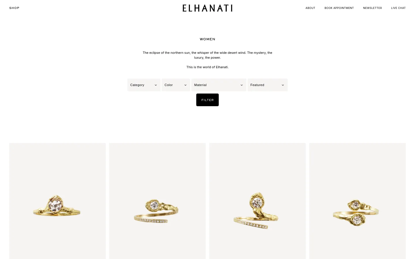 The desktop version of the Elhanati Women's collection page features a minimalist white layout with centered black text and a collection of diamond gold rings. A horizontal row of dropdown menus for Category, Color, Material, and Featured is positioned above a black 'FILTER' button. The product grid displays large, high-quality images of rings against a light cream background.