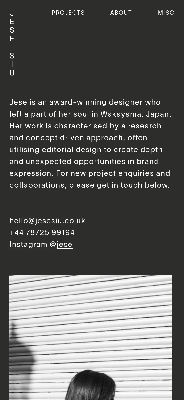 The mobile version uses a single-column vertical layout on a dark background. The biographical text and contact links appear first, followed by the large black and white portrait, with the lists of experience and clients positioned below.