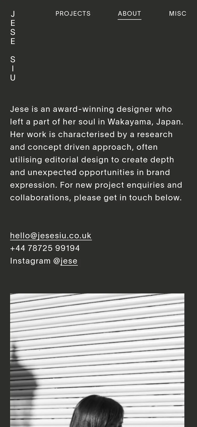 The mobile version uses a single-column vertical layout on a dark background. The biographical text and contact links appear first, followed by the large black and white portrait, with the lists of experience and clients positioned below.