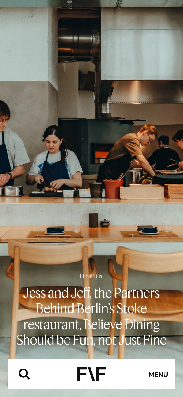 The mobile version displays a vertically oriented hero image of the restaurant kitchen with the headline positioned in the lower half. The navigation is condensed into a bottom bar containing a search icon, the central F/F logo, and a 'MENU' button. The overall aesthetic remains minimalist with a focus on large-scale imagery.