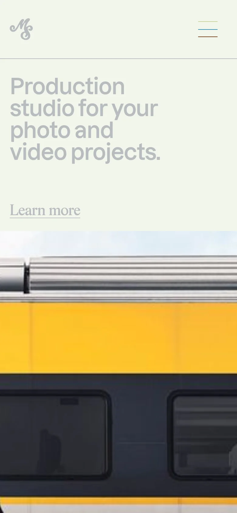 The mobile version simplifies the layout, centering the Mercredi Studio logo and a hamburger menu icon at the top. The large headline 'Production studio for your photo and video projects' is stacked vertically, followed by a 'Learn more' link, with the hero imagery appearing below in a single-column format.