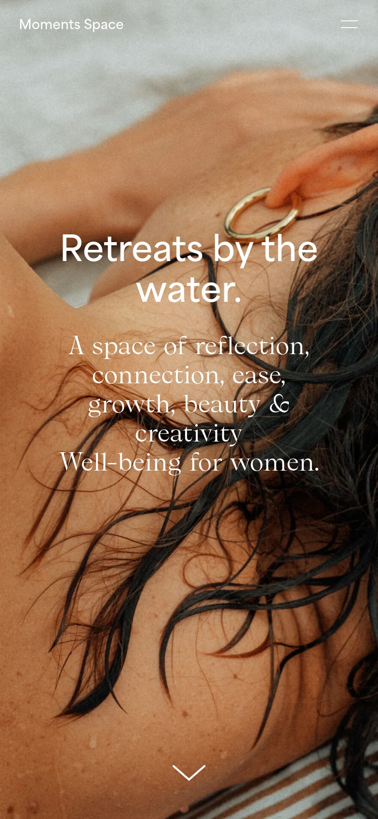 The mobile version displays the same hero image of a woman with wet hair, but the layout is vertically oriented. The navigation menu is condensed into a hamburger icon at the top right, and the central text is larger and centered to fit the narrow screen.
