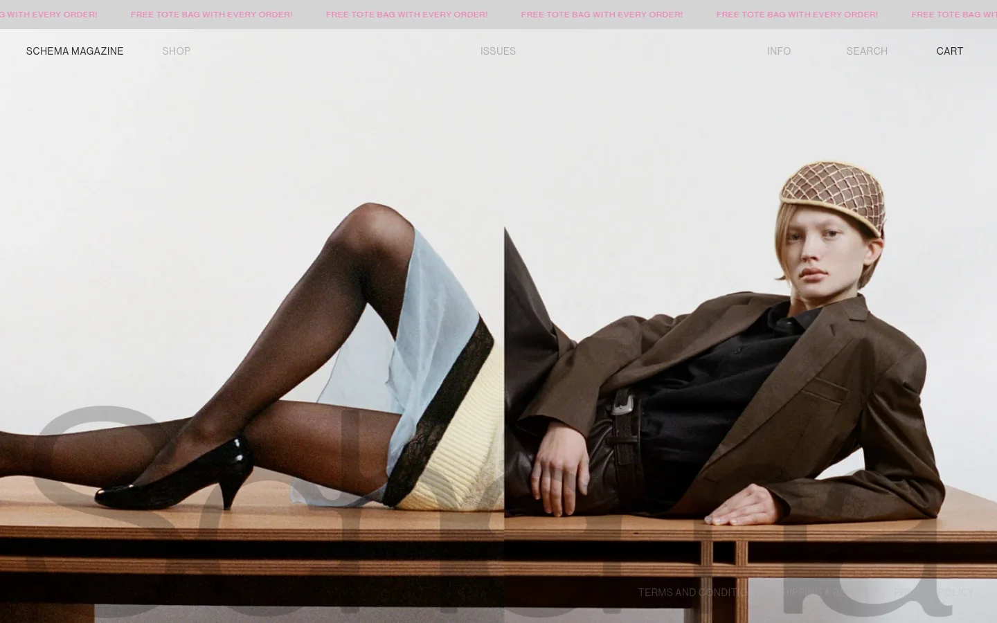 The desktop homepage features a minimalist design with a large hero image of a model in a brown suit and black shirt reclining on a wooden surface. A white navigation bar at the top includes links for Shop, Issues, Info, Search, and Cart, with a pink promotional banner reading 'FREE TOTE BAG WITH EVERY ORDER!' above it.
