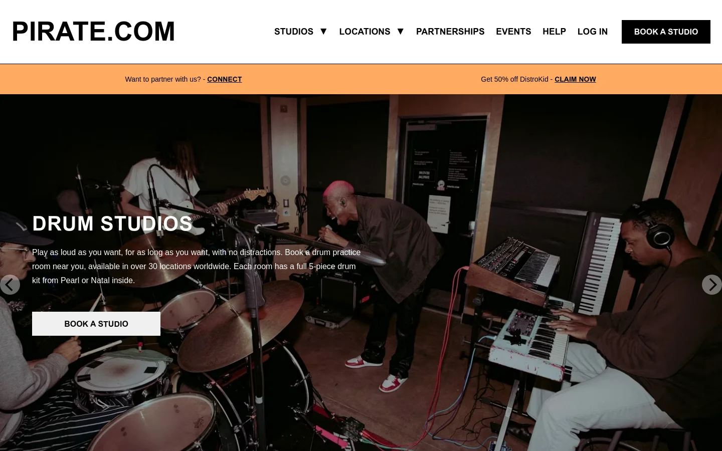The desktop page features a dark theme with a large hero image of musicians practicing in a studio. A prominent headline reads 'DRUM STUDIOS' above a description and a white 'BOOK A STUDIO' call-to-action button. A navigation bar at the top includes the Pirate logo and links for Studios, Locations, Partnerships, Events, Help, and Log In.