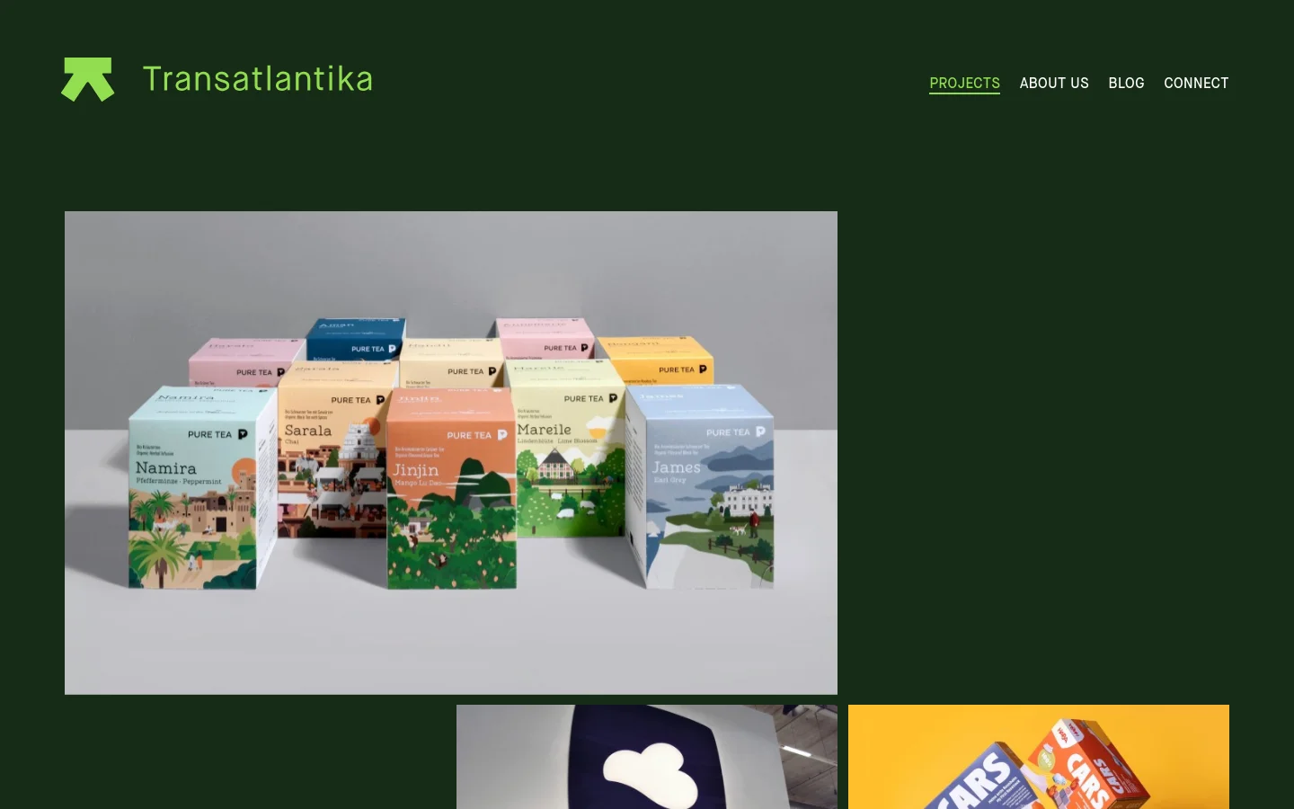The Transatlantika homepage features a dark green background with a minimalist header containing the agency logo and navigation links for Projects, About Us, Blog, and Connect. Below the header, a grid of large, high-quality project images showcases diverse creative work such as colorful tea packaging, a corporate logo, and toy packaging. The layout is spacious and clean, emphasizing visual portfolio items.