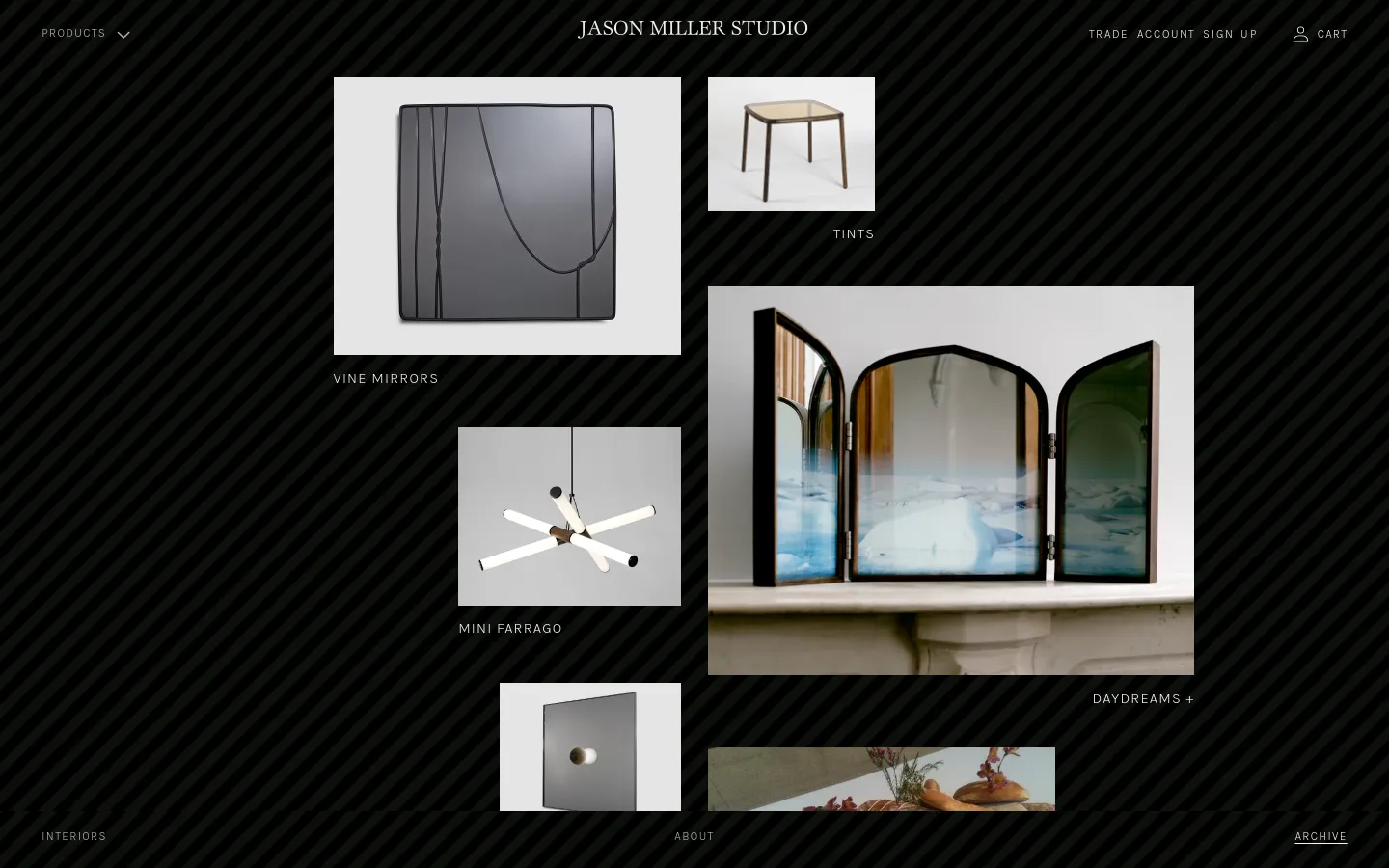 The Archive page features a grid layout of design project images against a dark, diagonally striped background. Each entry consists of a rectangular product photograph above its corresponding title, such as 'Vine Mirrors' and 'Tints'. The navigation menu is at the top with links for Products, Trade Account, and Cart.