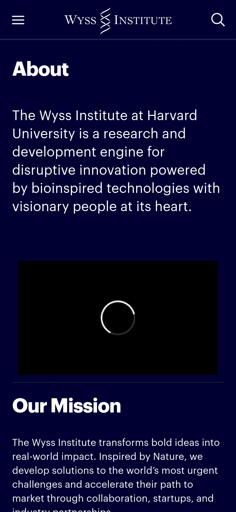 The mobile version uses a similar dark navy theme but features a condensed layout. The navigation is simplified with a hamburger menu icon on the left and a search icon on the right, both flanking the Wyss Institute logo. The 'About' headline and mission text are stacked vertically above the large black video placeholder.