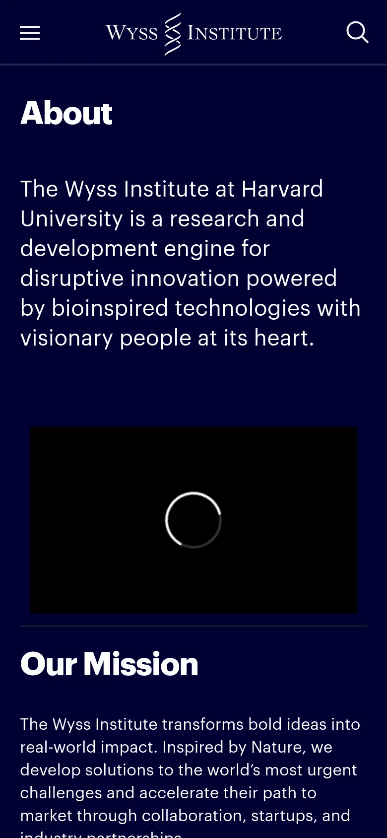 The mobile version uses a similar dark navy theme but features a condensed layout. The navigation is simplified with a hamburger menu icon on the left and a search icon on the right, both flanking the Wyss Institute logo. The 'About' headline and mission text are stacked vertically above the large black video placeholder.