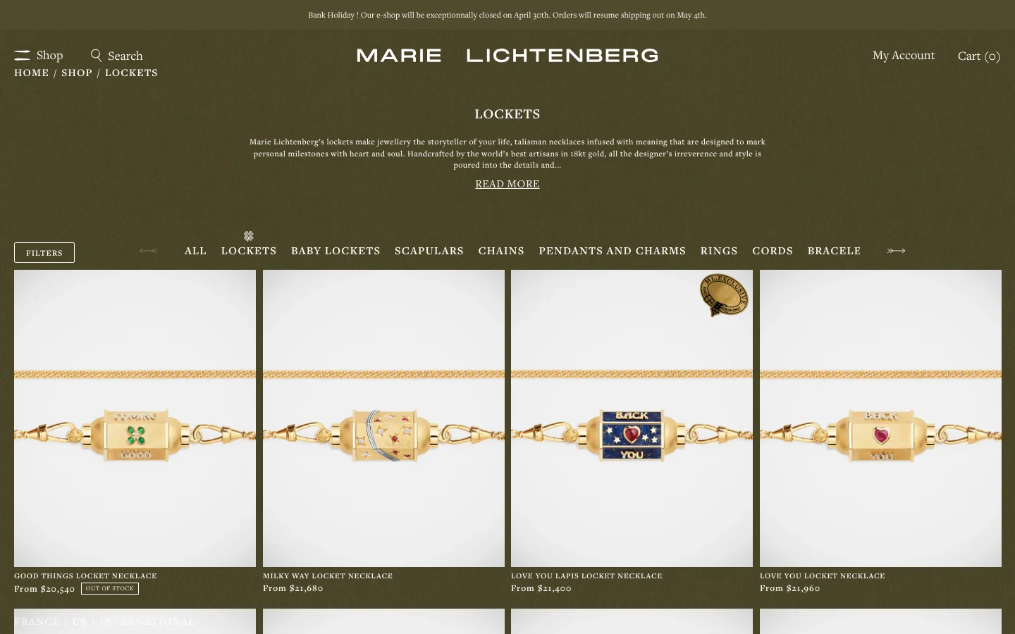 The desktop version of the Marie Lichtenberg Lockets collection page features a dark olive green background with white text. A centered hero section includes the brand name, a collection title, a brief description, and a 'READ MORE' link, followed by a horizontal navigation menu of jewelry categories and a grid of product images showcasing gold locket necklaces.