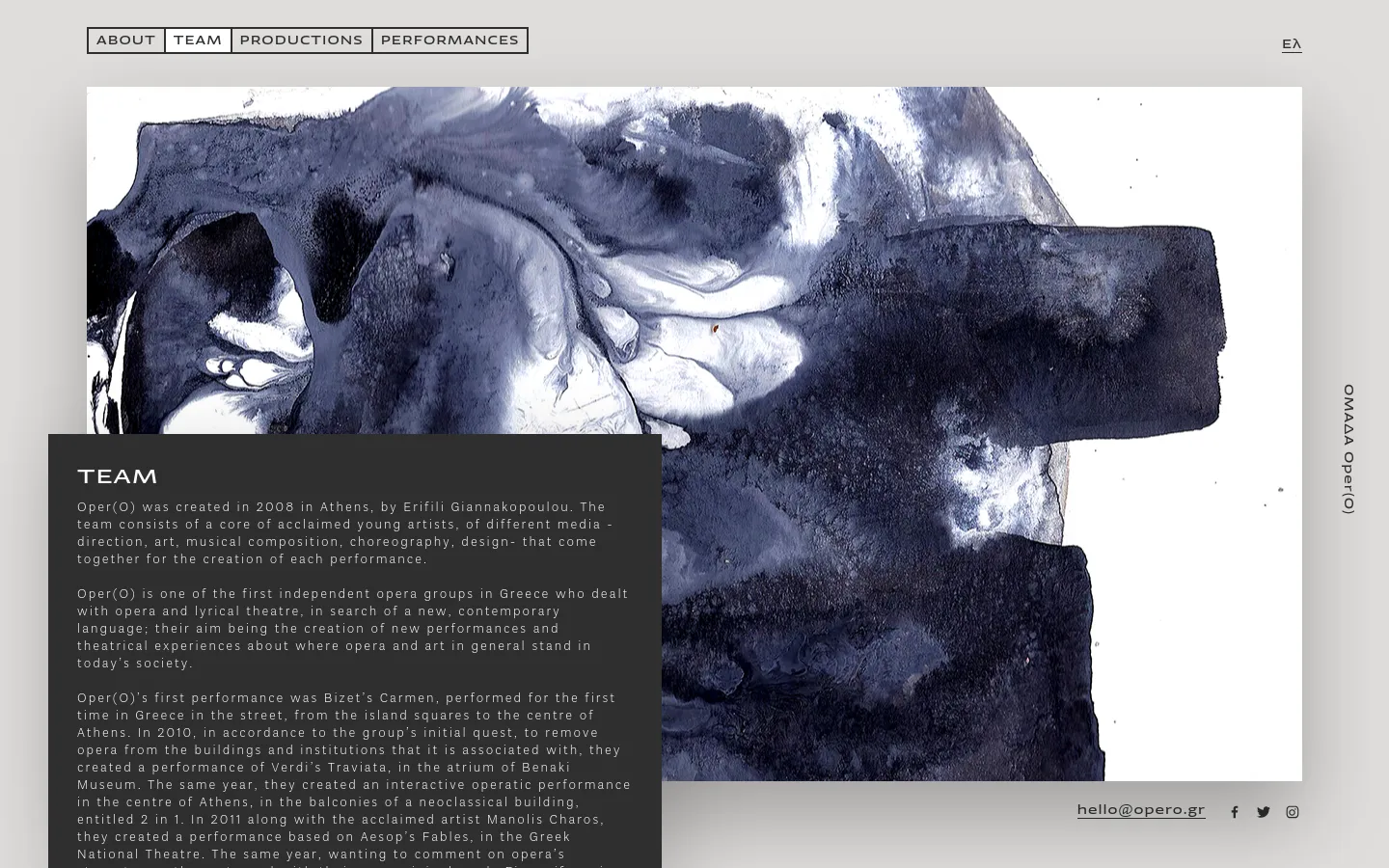 The desktop page features a minimalist design with a large, abstract blue and white watercolor-style image spanning the width of the screen. A dark semi-transparent text box on the left contains the 'TEAM' headline and several paragraphs of descriptive text about the group. A navigation menu is at the top, and contact information with social media icons is located in the bottom right corner.
