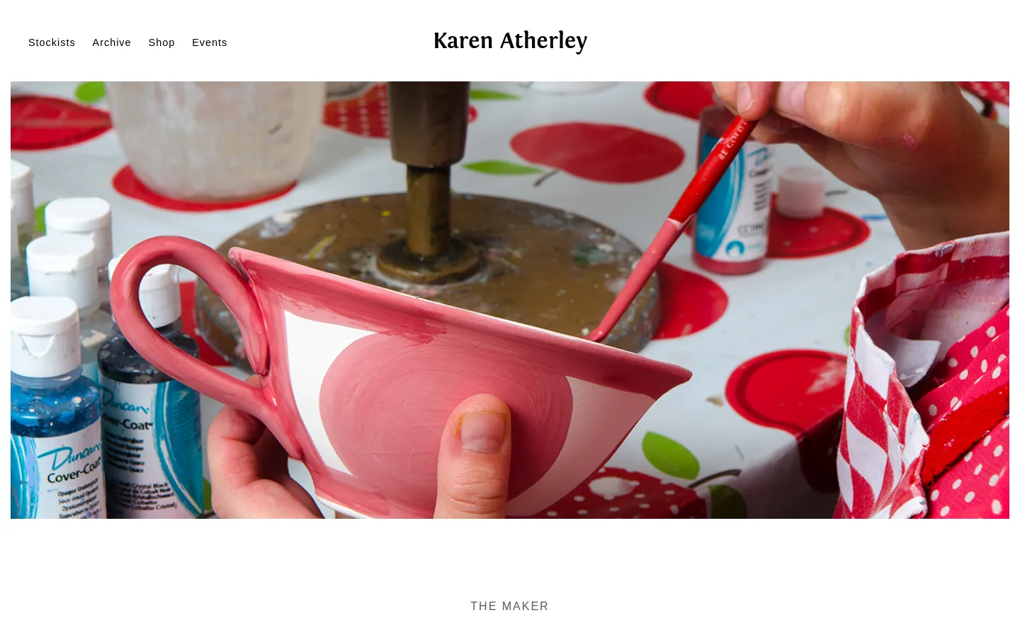 The desktop homepage for Karen Atherley Ceramics features a large hero image of hands painting a pink and white ceramic cup at a pottery wheel. A clean white navigation bar at the top contains links for Stockists, Archive, Shop, and Events, with the brand name centered in a serif font.