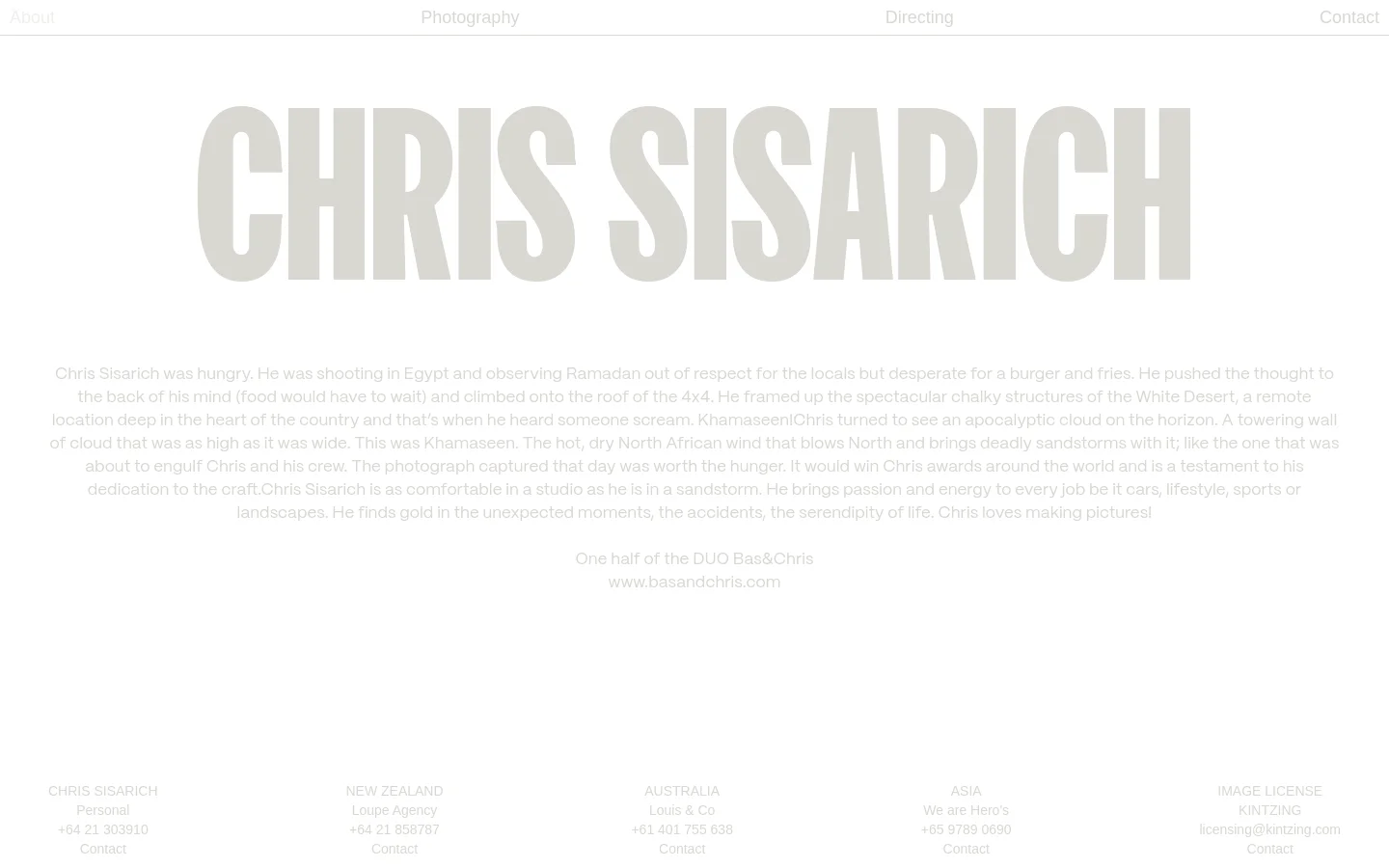 The desktop About page features a minimalist white background with large, light gray typography for the name 'CHRIS SISARICH' as a hero element. Below the headline, a biographical text block describes the photographer's experiences, followed by a multi-column layout of contact information for different regions and agencies. Navigation links are positioned at the top and bottom of the page.