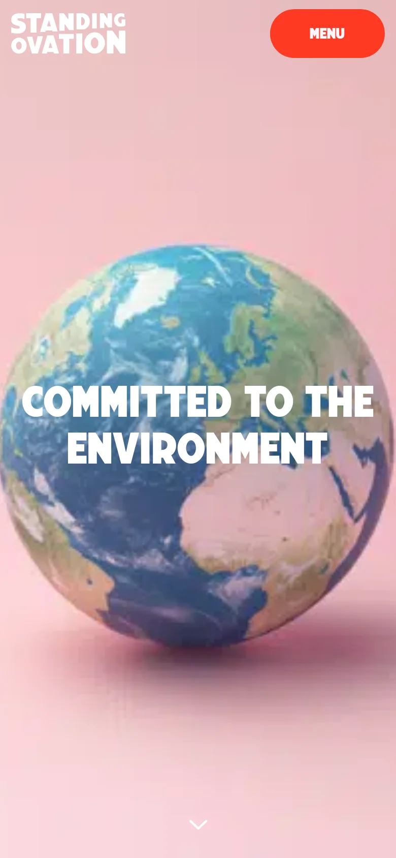 The mobile version simplifies the layout, replacing the top navigation bar with a prominent red 'MENU' button in the upper right corner. The hero section remains centered, featuring the large white headline 'COMMITTED TO THE ENVIRONMENT' overlaid on a 3D globe against a pink background, with a downward arrow at the bottom to indicate more content.
