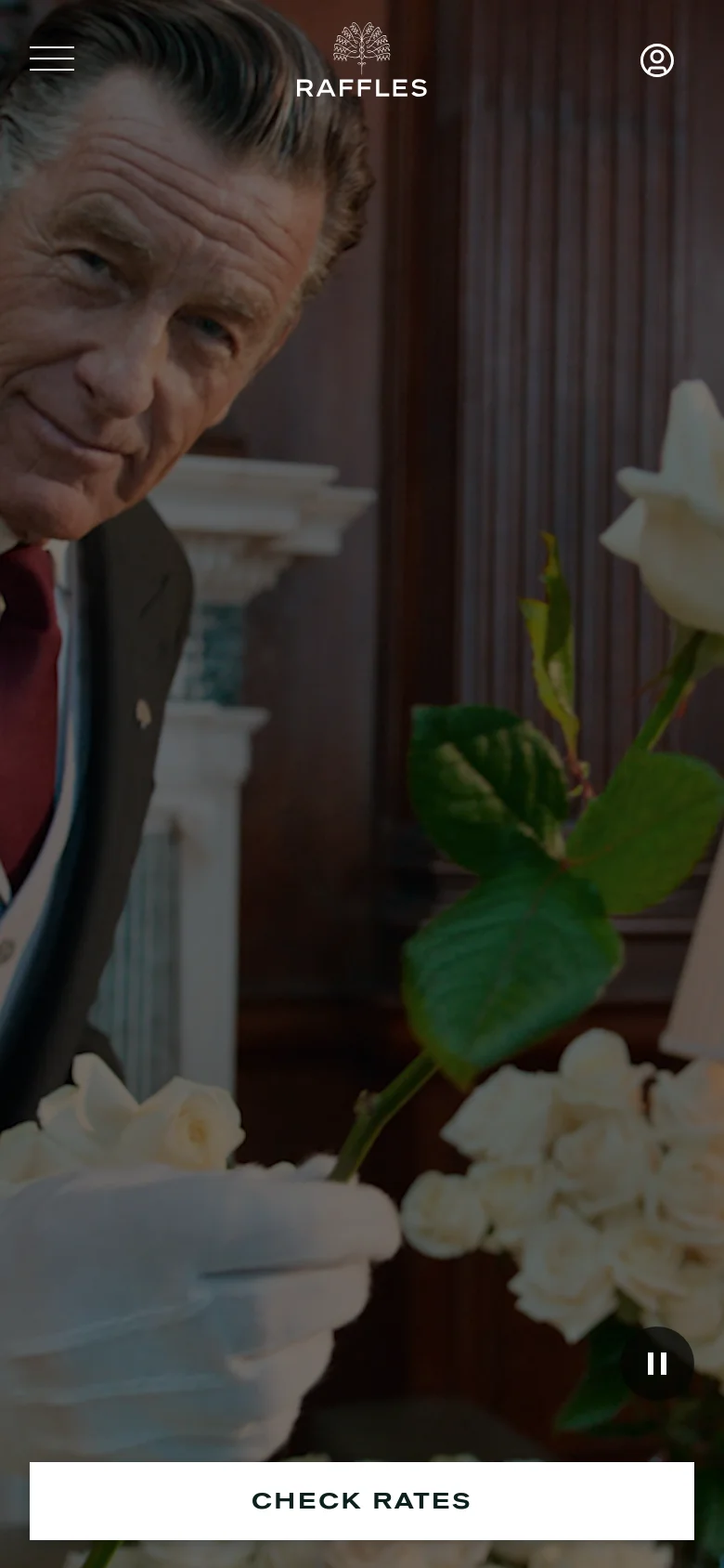 The mobile version presents a full-screen hero image of a person with white roses, with the Raffles logo and account icon at the top. The layout is simplified, featuring a prominent white 'CHECK RATES' button spanning the width of the screen at the bottom, while the booking input fields are hidden from the main view.