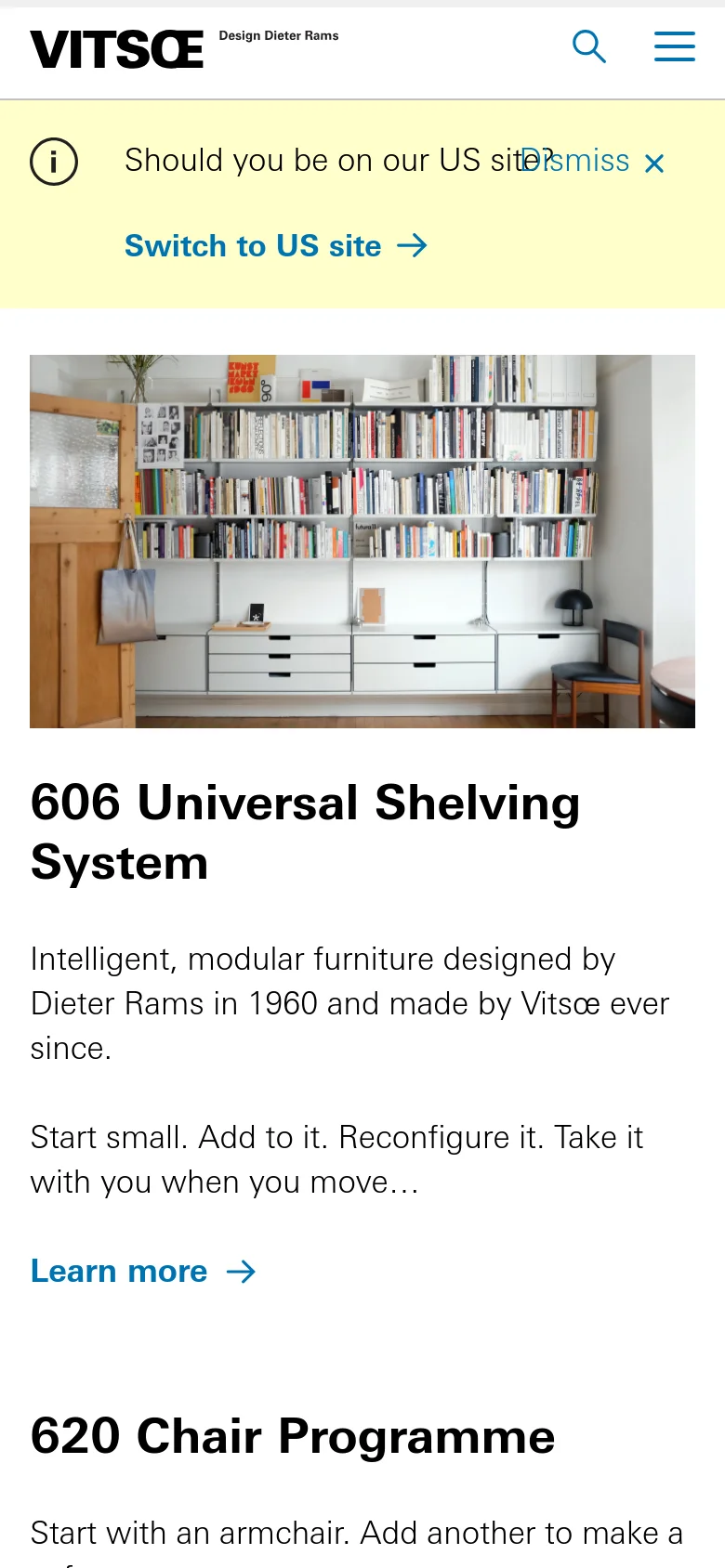 The mobile version presents a single-column layout optimized for vertical scrolling. The hero image of the shelving system spans the width of the screen, followed by stacked text sections for the 606 Shelving System, 620 Chair Programme, and 621 Table. The navigation is condensed into a hamburger menu next to the Vitsœ logo, and the yellow site-switch banner remains prominent at the top.