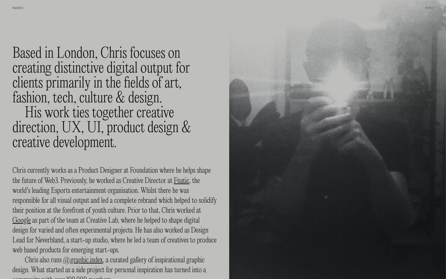 The desktop page features a minimalist two-column layout with a light gray background. The left side contains large, serif typography introducing Chris Biron, followed by detailed biographical text and a list of selected clients. The right side is occupied by a large, high-contrast black and white photographic image of a person.